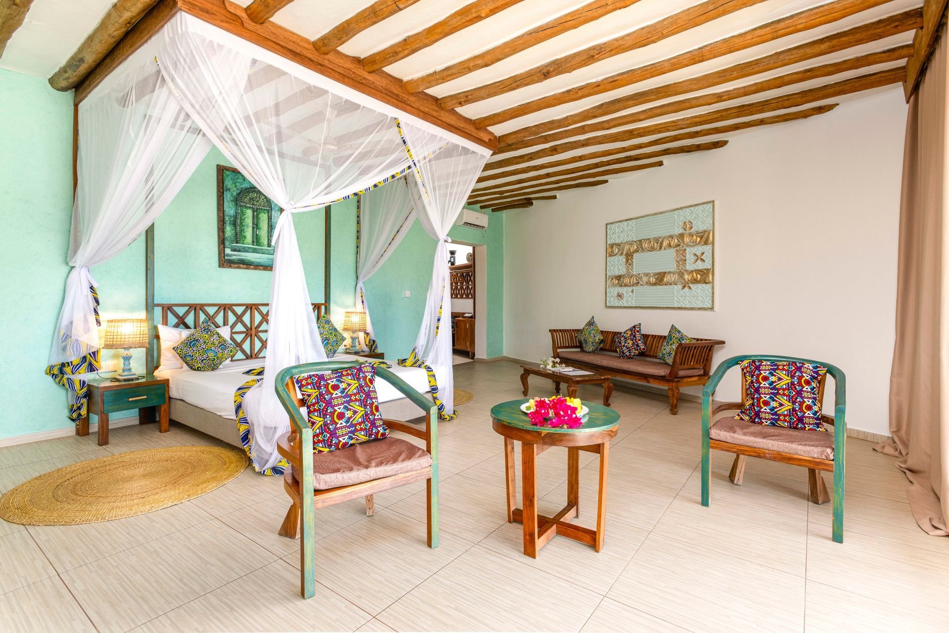 Mint-green room with colourful Swahili textiles