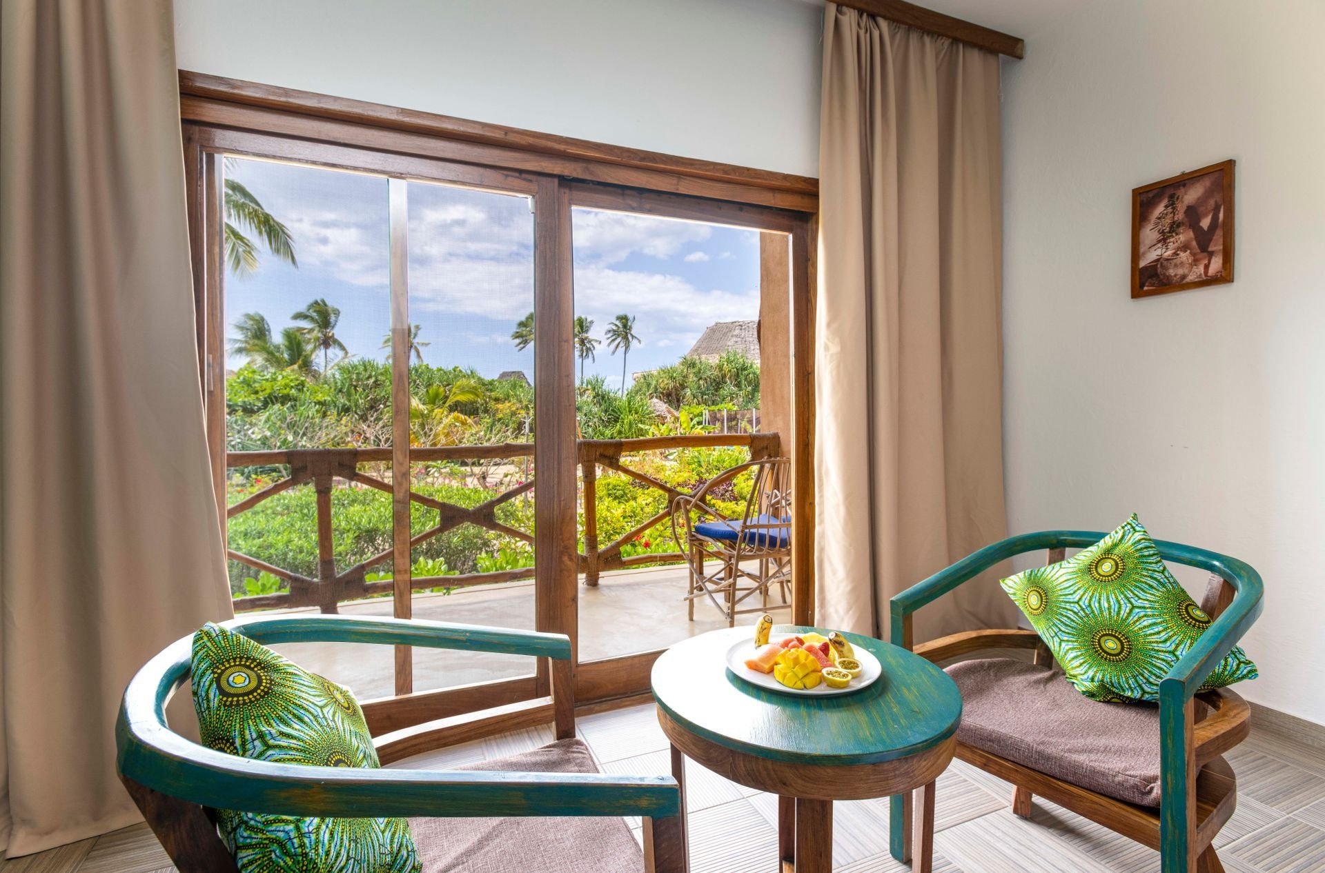 Private balcony with green carved chairs overlooking the gardens